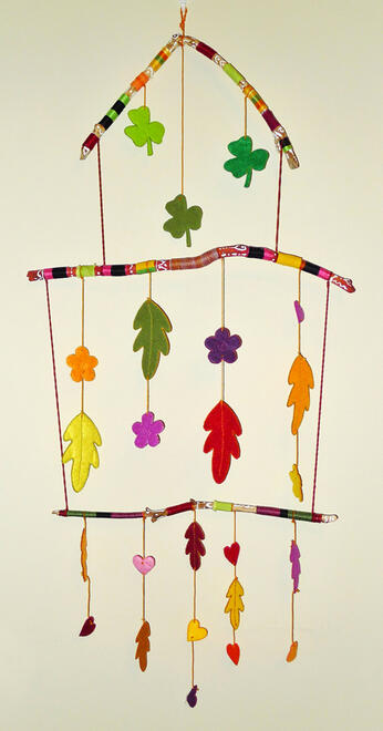 Wall hanging made with sticks and felt elements